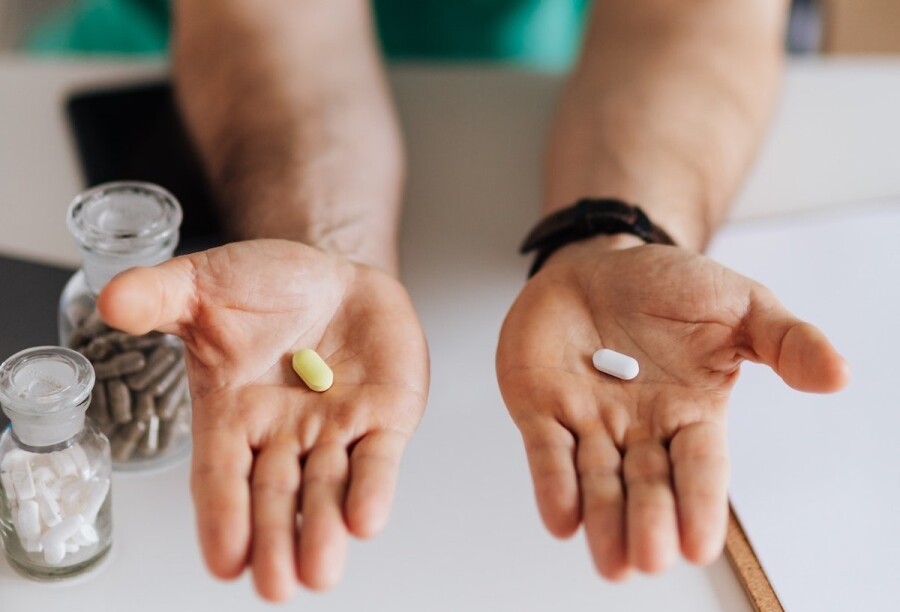 healthcare professional assessing a choice of tablets for consideration
