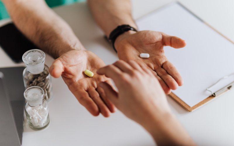 healthcare professional weighing up the choice of medications for a patient